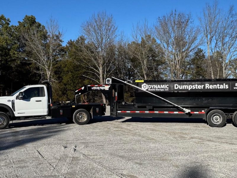 Dynamic Mobile Storage's truck delivering a dumpster rental